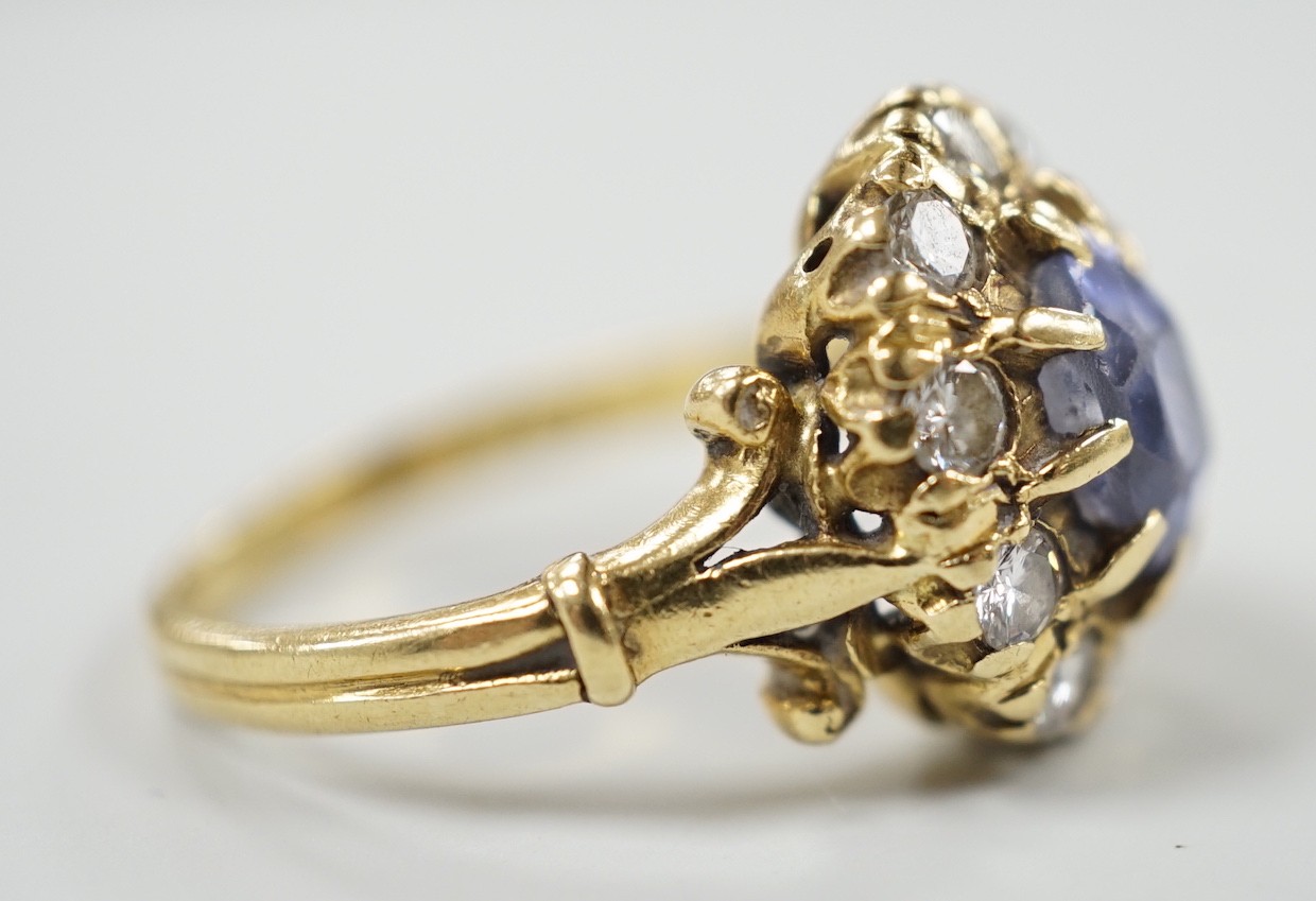 An early to mid 20th century yellow metal, sapphire and diamond set oval cluster dress ring, size